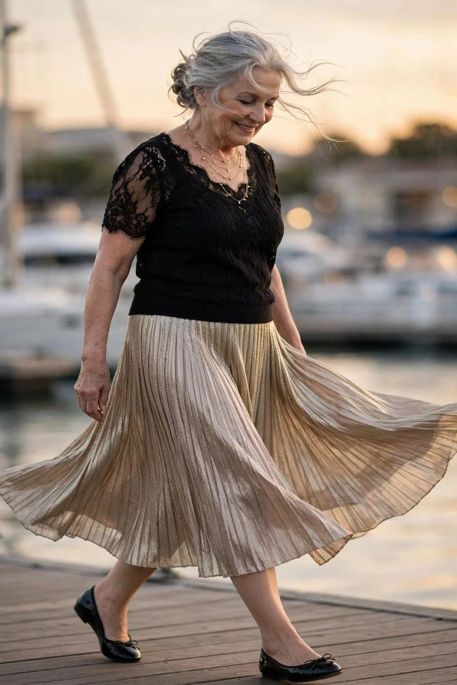 Elegant woman in champagne pleated midi skirt with black top celebrating