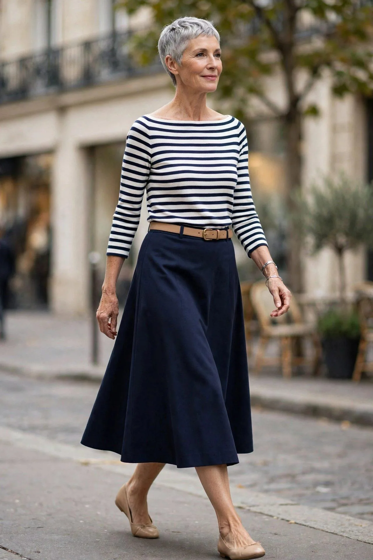 Woman in her sixties in navy midi skirt with striped Breton top.
