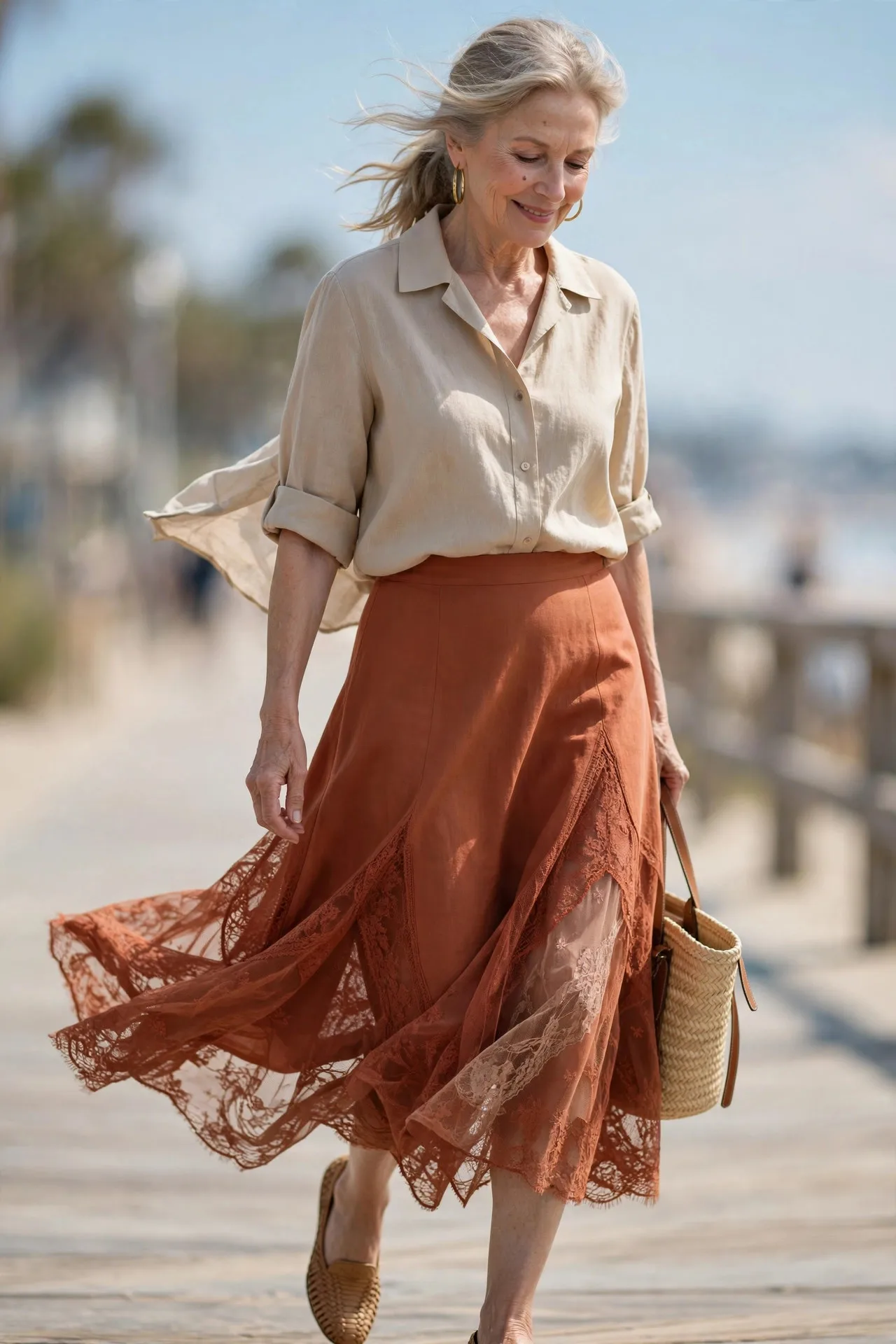 Linen Ease — A sand-colored linen camp-collar shirt with sleeves rolled to the elbow, tucked into a high-waisted terracotta A-line midi skirt, finished with woven leather flats.