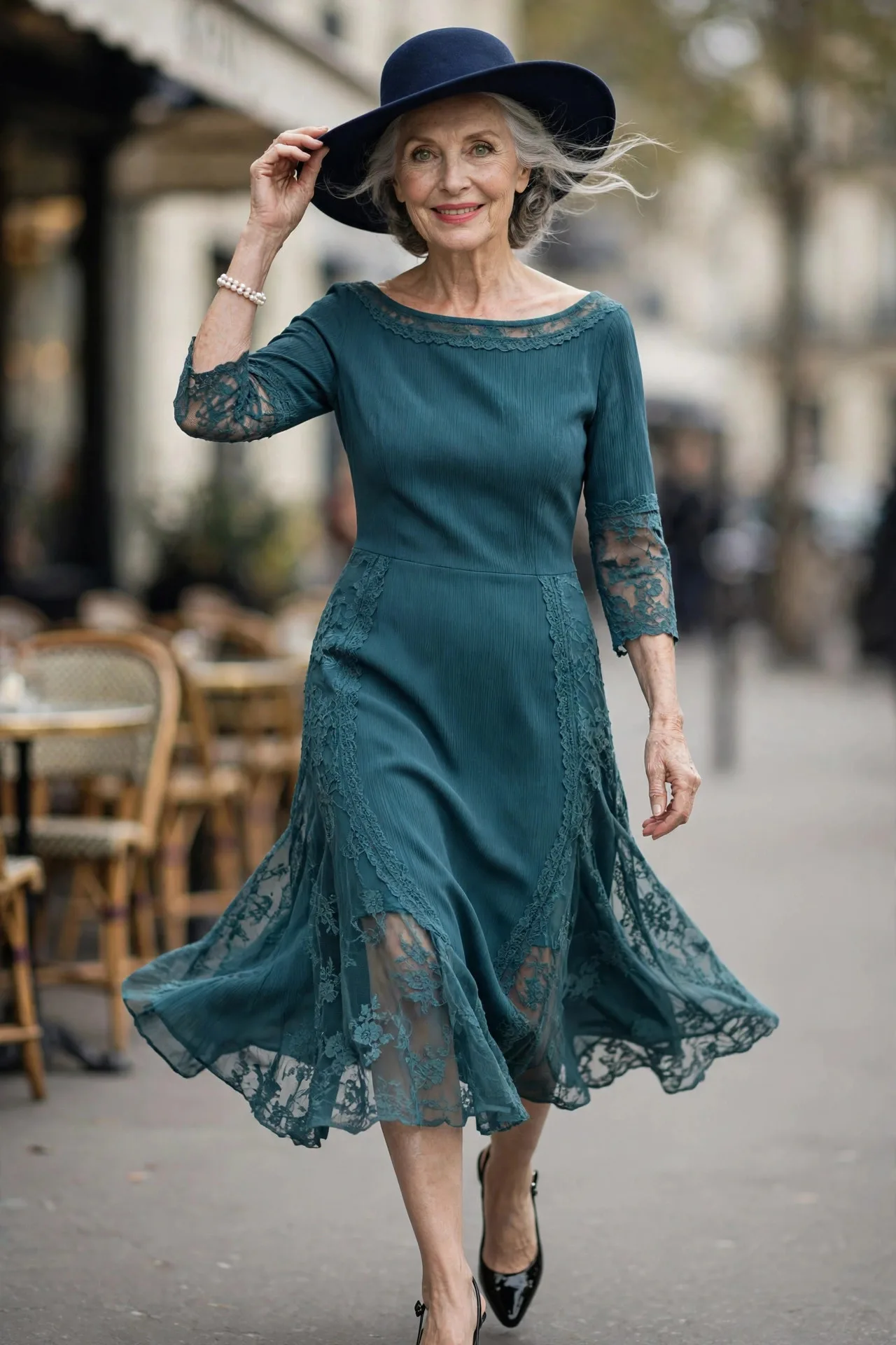 Chic mature woman wearing teal crepe sheath dress with bateau neckline