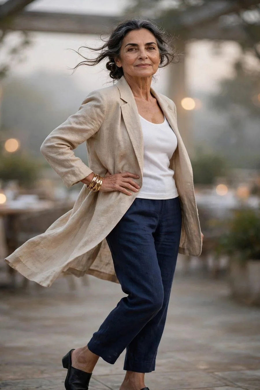 Elegant woman in sand linen blazer with navy ankle pants at restaurant