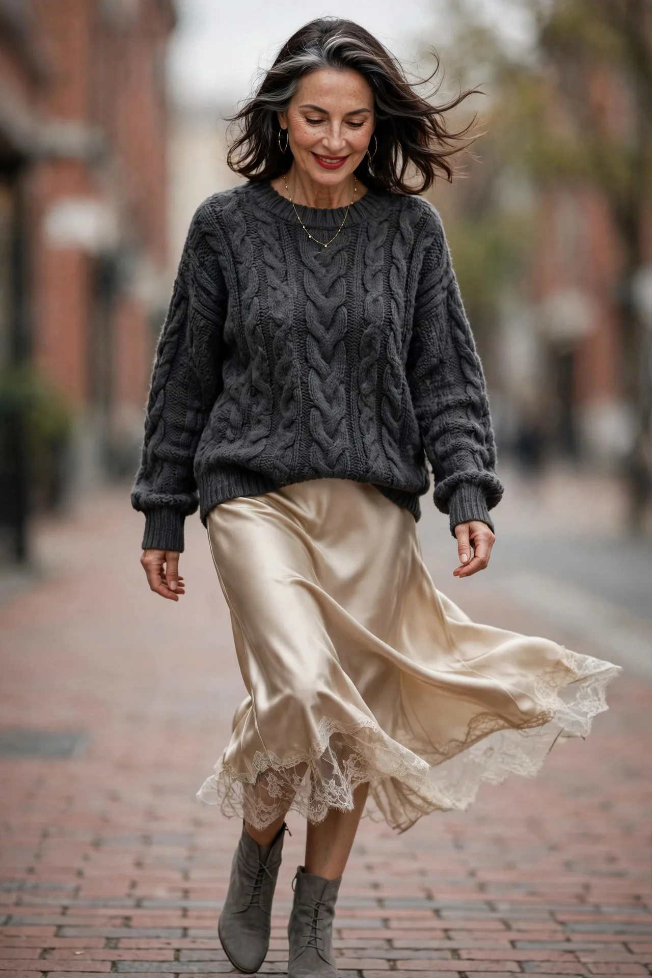 Charcoal Knit Glow — A charcoal chunky cable-knit wool sweater with a champagne satin slip skirt, grey suede ankle boots and a delicate gold necklace.