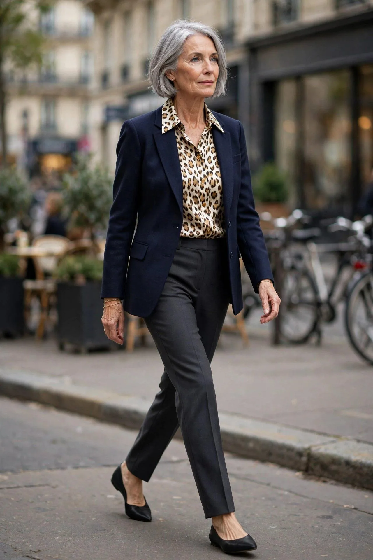 Sophisticated lady over 50 wearing spotted silk blouse beneath tailored navy blazer