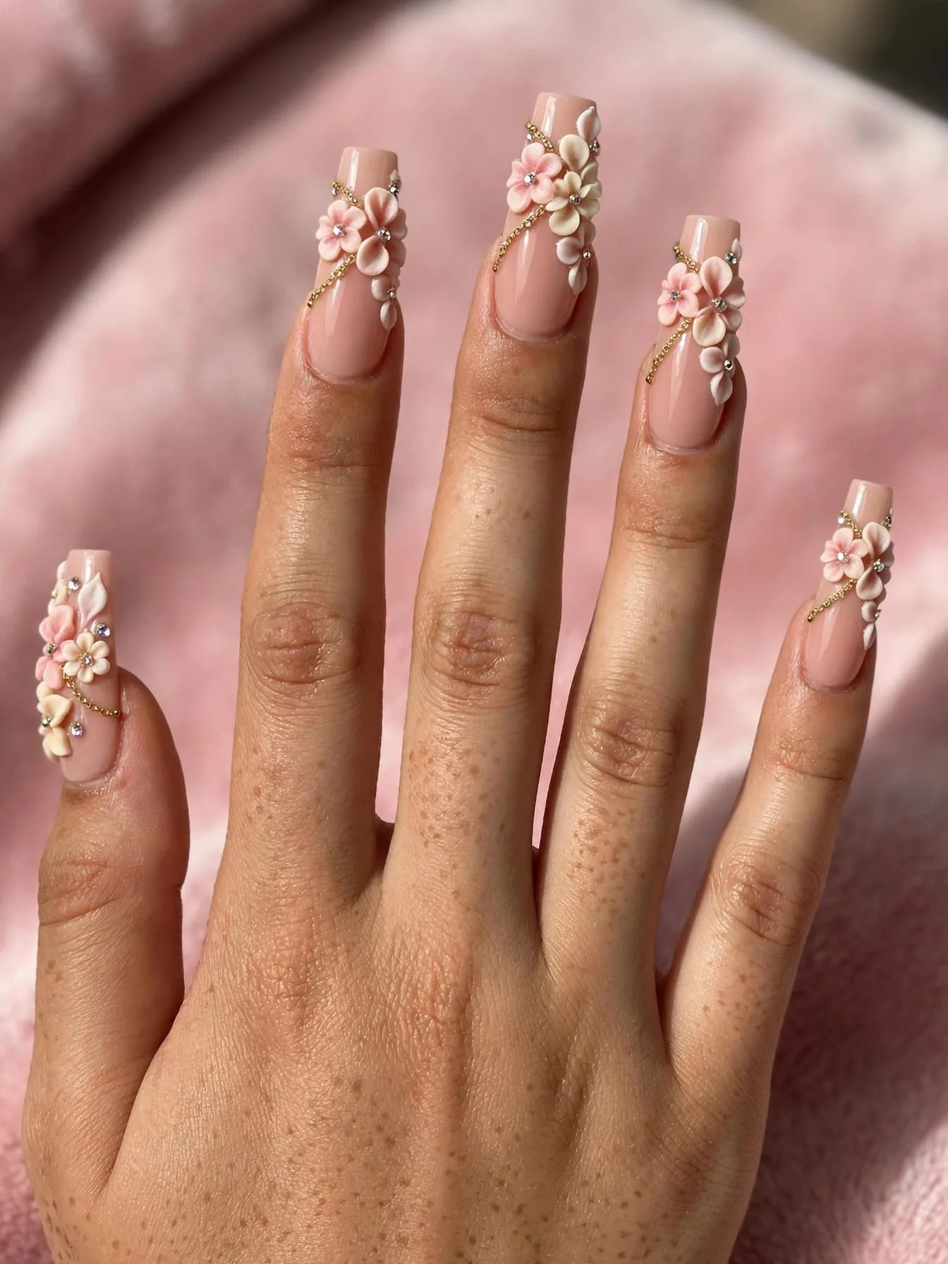 Long coffin nails with 3D flowers, rhinestones and gold chains.