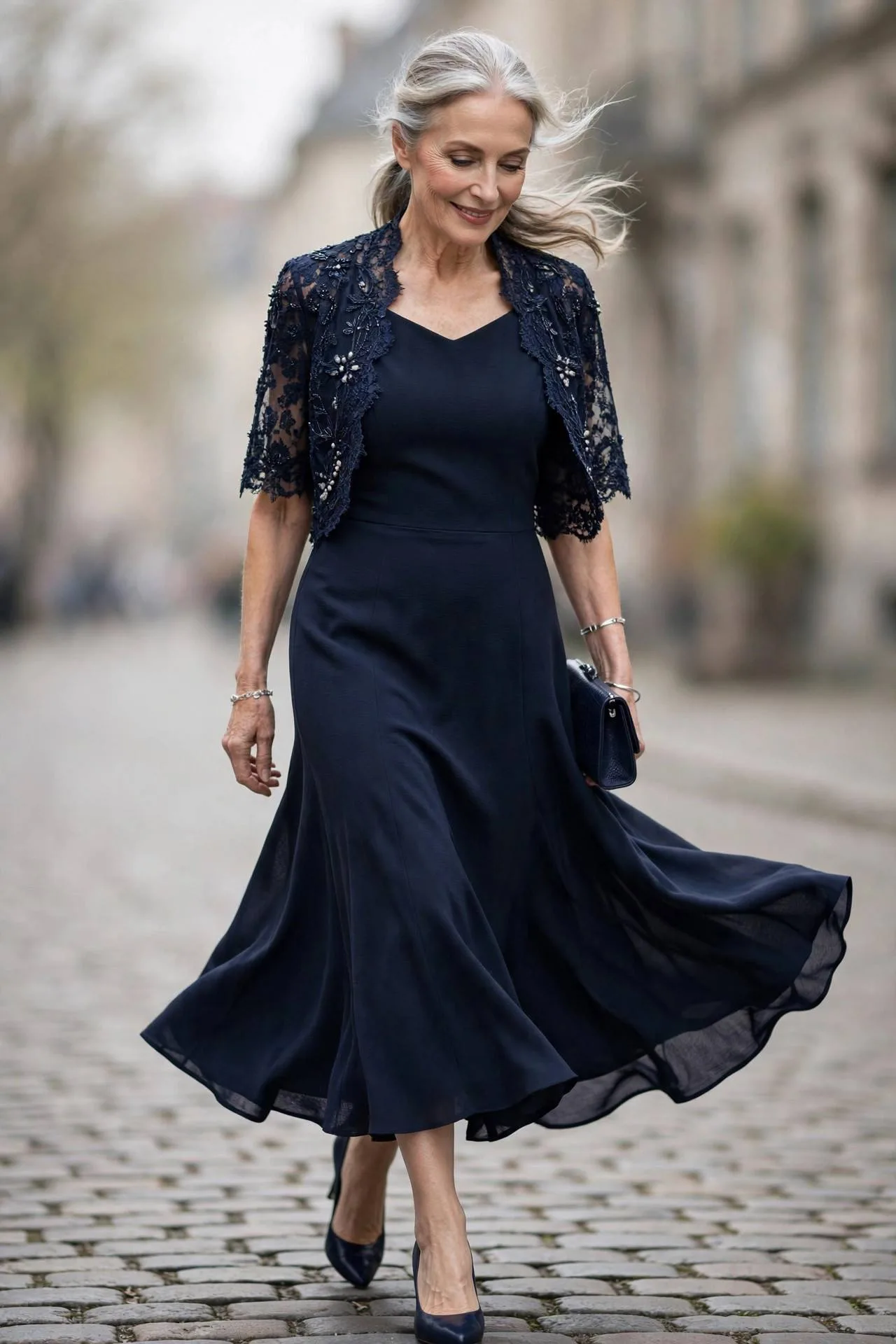 Elegant woman in navy sheath dress with beaded bolero jacket