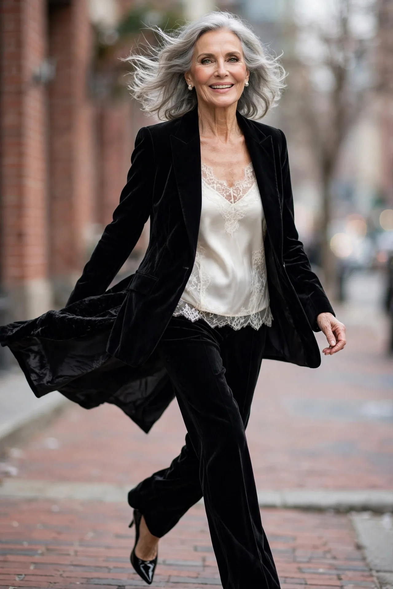 Classic Black Velvet Suit — A black velvet notch-lapel blazer with matching straight-leg velvet trousers, worn over an ivory silk camisole, with black patent pointed-toe pumps.