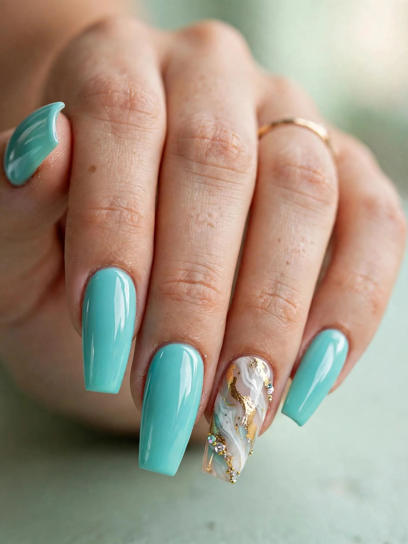 Long coffin nails in tiffany blue with white-gold marble accent and crystals.