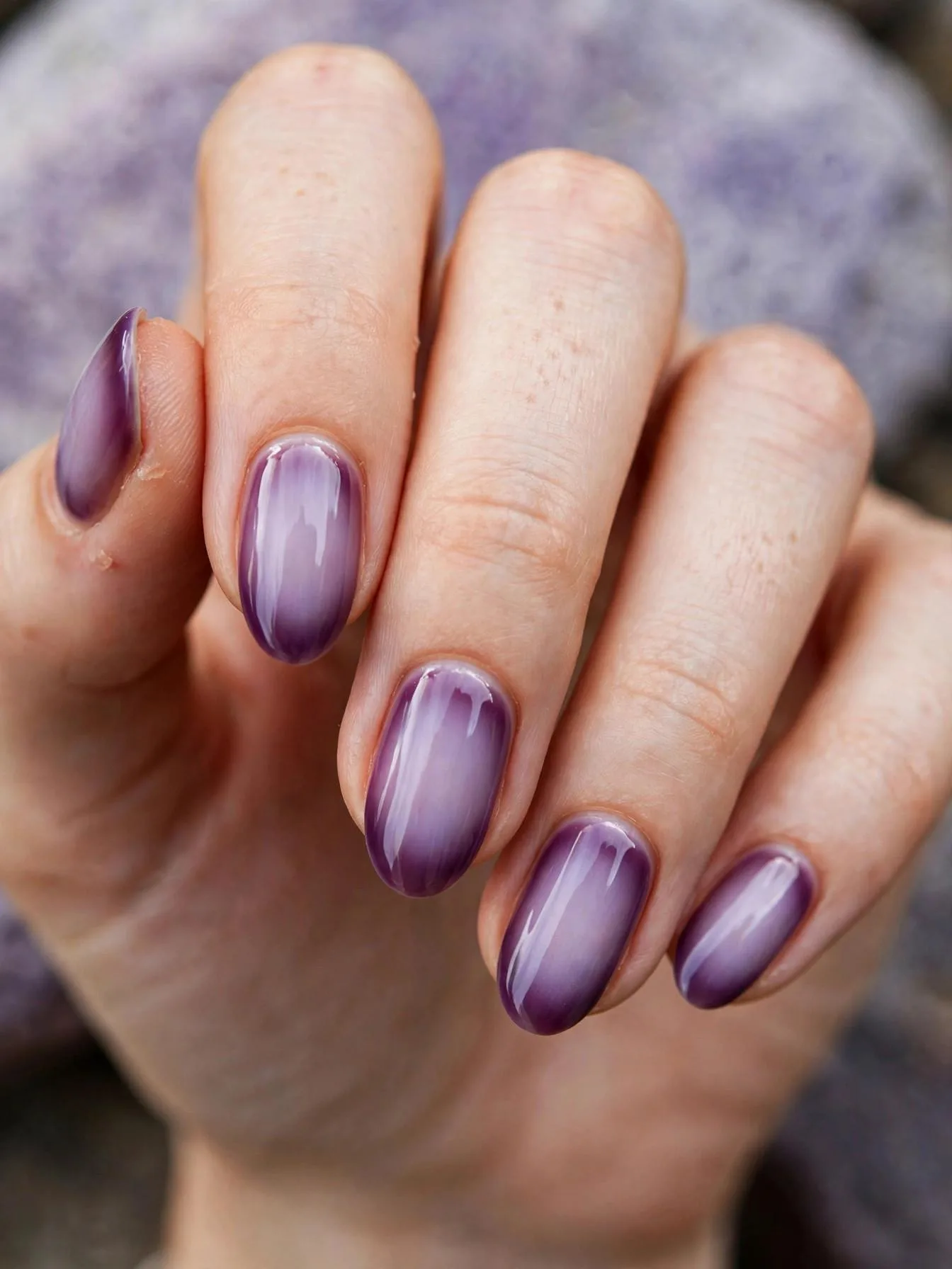 Short almond nails with smoky lavender aura blending into plum.
